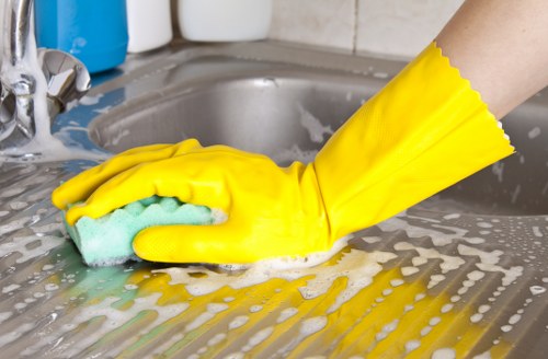 Trained technician cleaning an oven with careful safety practices